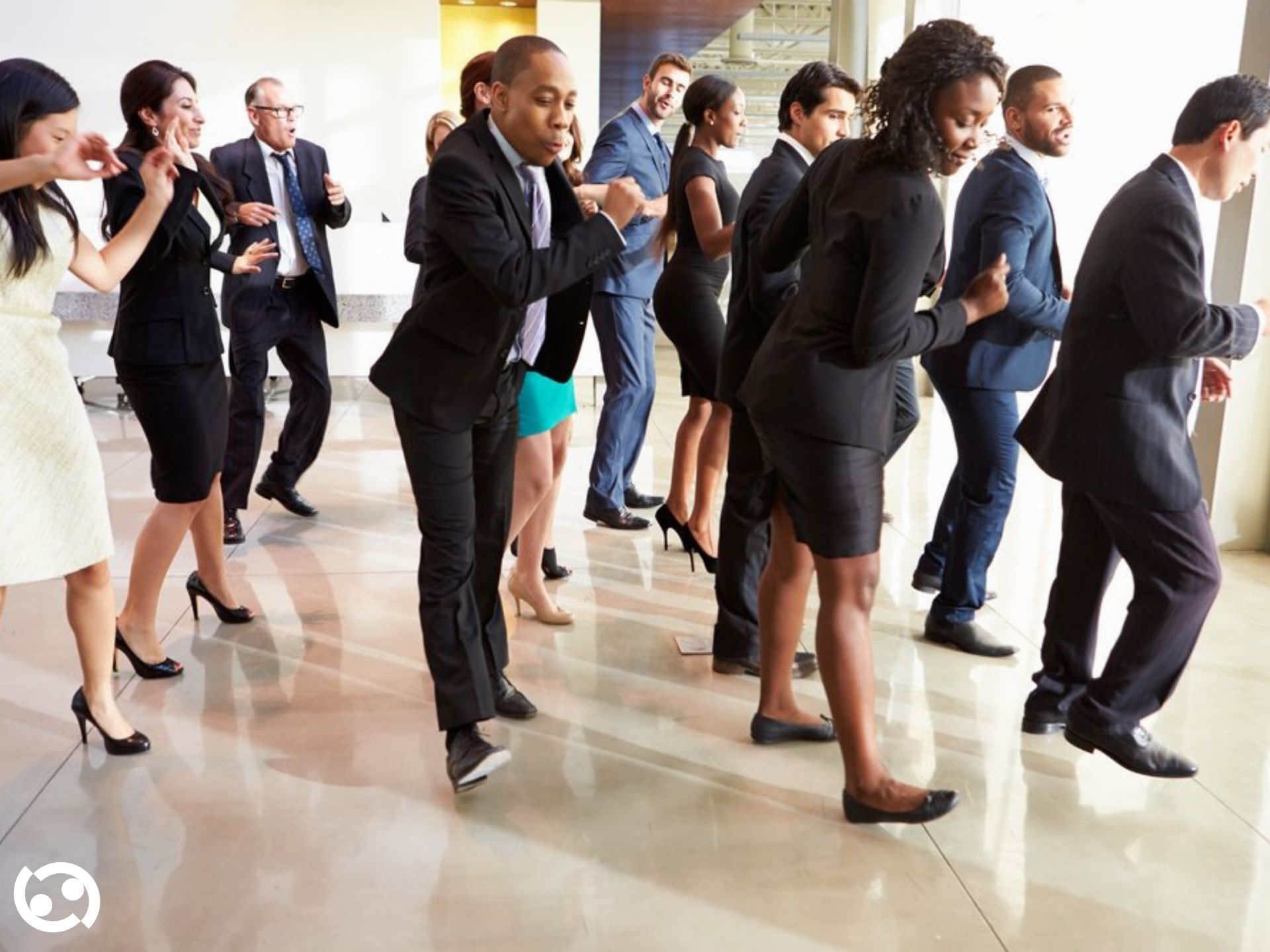 A group dancing together in a studio team-building session